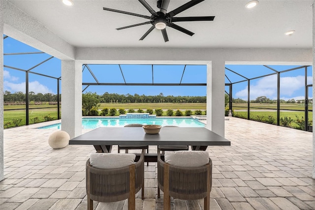 33774 Castaway Loop, Wesley Chapel, FL 33543 - view of patio featuring ceiling fan, glass enclosure, an outdoor pool, and outdoor dining space