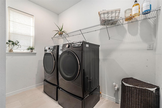 33774 Castaway Loop, Wesley Chapel, FL 33543 - laundry area with washer and clothes dryer and baseboards