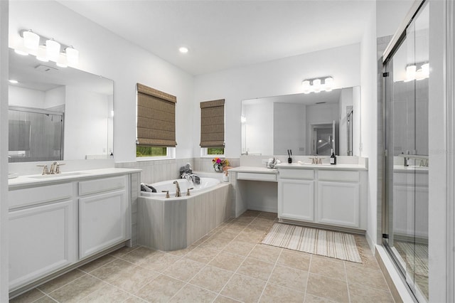 33774 Castaway Loop, Wesley Chapel, FL 33543 - full bathroom with a shower stall, two vanities, a bath, tile patterned floors, and recessed lighting