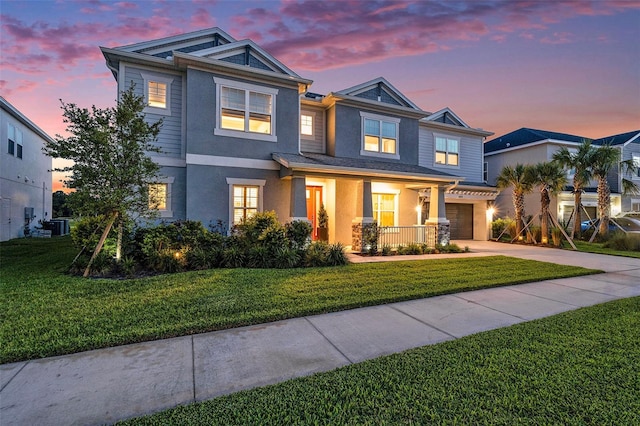 33774 Castaway Loop, Wesley Chapel, FL 33543 - view of front of home with a garage, stucco siding, driveway, and a yard