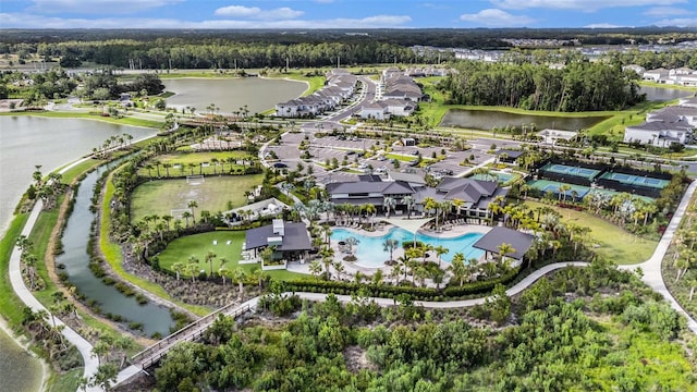 33774 Castaway Loop, Wesley Chapel, FL 33543 - aerial view of property and surrounding area with a nearby body of water, a pool area, and nearby suburban area
