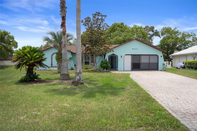8332 Berkeley Manor Blvd, Spring Hill, FL 34606 - view of front of house with decorative driveway, a garage, a front yard, and stucco siding