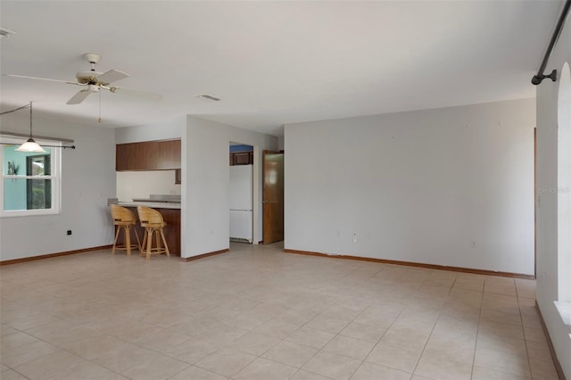 8332 Berkeley Manor Blvd, Spring Hill, FL 34606 - unfurnished living room featuring baseboards and a ceiling fan
