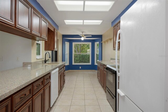 8332 Berkeley Manor Blvd, Spring Hill, FL 34606 - kitchen with white appliances, a sink, light tile patterned floors, a ceiling fan, and light stone counters