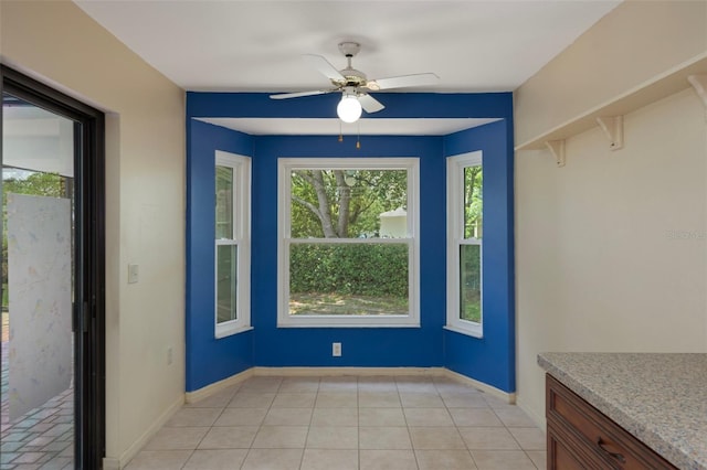 8332 Berkeley Manor Blvd, Spring Hill, FL 34606 - unfurnished dining area with a ceiling fan, baseboards, and light tile patterned flooring
