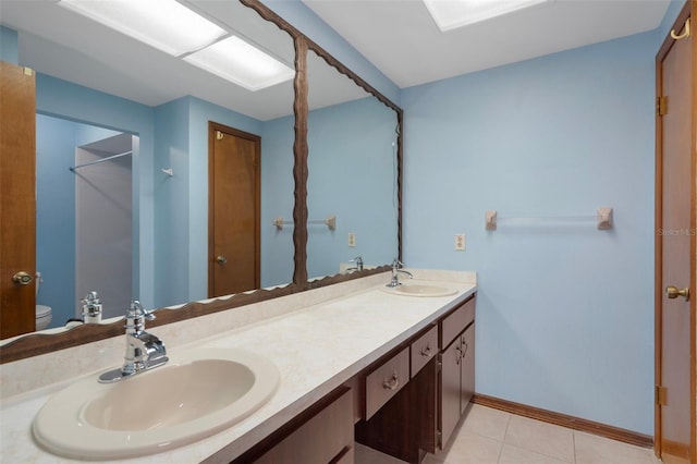 8332 Berkeley Manor Blvd, Spring Hill, FL 34606 - full bath with toilet, double vanity, tile patterned flooring, and baseboards