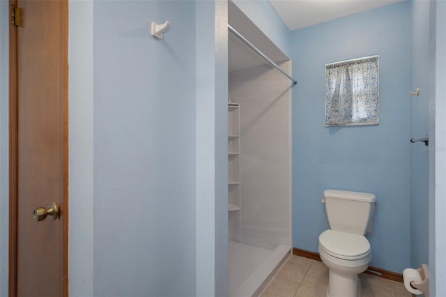 8332 Berkeley Manor Blvd, Spring Hill, FL 34606 - full bathroom with toilet, tile patterned floors, a shower stall, and baseboards