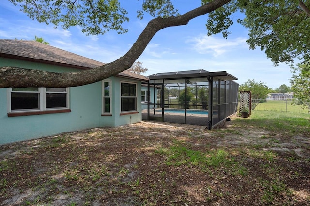 8332 Berkeley Manor Blvd, Spring Hill, FL 34606 - rear view of house with an outdoor pool, glass enclosure, and stucco siding