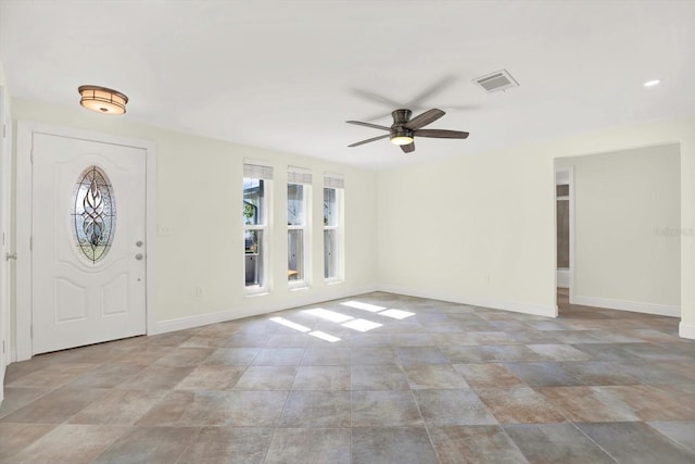 13926 Darlene Ave, Hudson, FL 34667 - entrance foyer with ceiling fan, baseboards, and stone finish floors