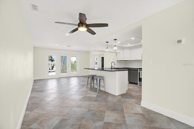 13926 Darlene Ave, Hudson, FL 34667 - kitchen with dark countertops, baseboards, recessed lighting, open floor plan, and decorative backsplash