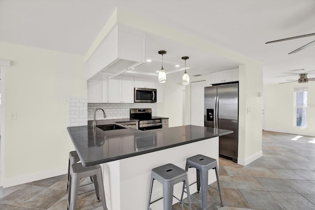 13926 Darlene Ave, Hudson, FL 34667 - kitchen with appliances with stainless steel finishes, a sink, baseboards, a peninsula, and tasteful backsplash