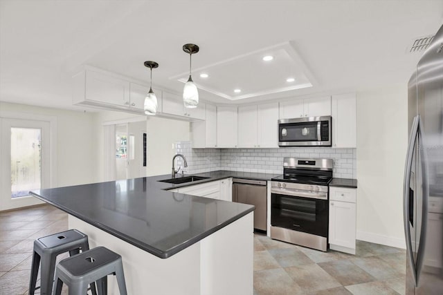 13926 Darlene Ave, Hudson, FL 34667 - kitchen with appliances with stainless steel finishes, a sink, dark countertops, a kitchen breakfast bar, and tasteful backsplash