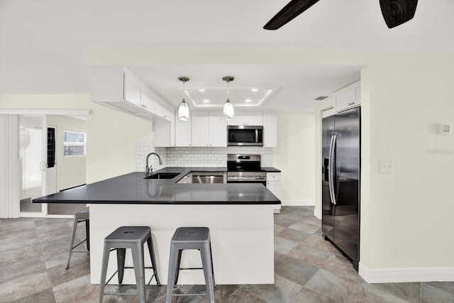 13926 Darlene Ave, Hudson, FL 34667 - kitchen with stainless steel appliances, a sink, a tray ceiling, a peninsula, and recessed lighting