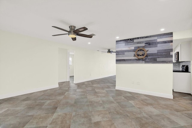 13926 Darlene Ave, Hudson, FL 34667 - unfurnished living room with ceiling fan, recessed lighting, and baseboards
