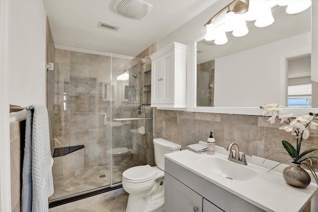13926 Darlene Ave, Hudson, FL 34667 - full bath with tile walls, toilet, vanity, a shower stall, and tile patterned floors