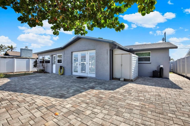 13926 Darlene Ave, Hudson, FL 34667 - rear view of house featuring french doors, stucco siding, a patio area, and a fenced backyard