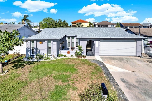 13926 Darlene Ave, Hudson, FL 34667 - view of front facade with a garage, stucco siding, concrete driveway, and roof with shingles