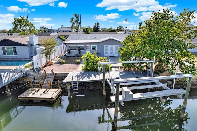 13926 Darlene Ave, Hudson, FL 34667 - dock area with boat lift, a fenced backyard, and a water view