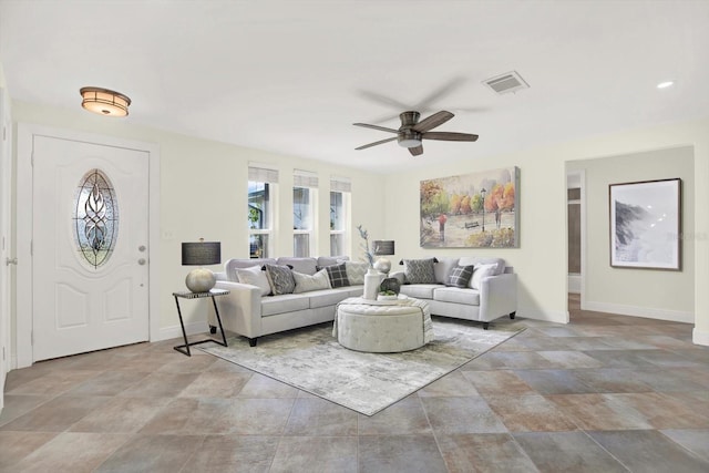 13926 Darlene Ave, Hudson, FL 34667 - living room with ceiling fan, stone finish floors, and baseboards