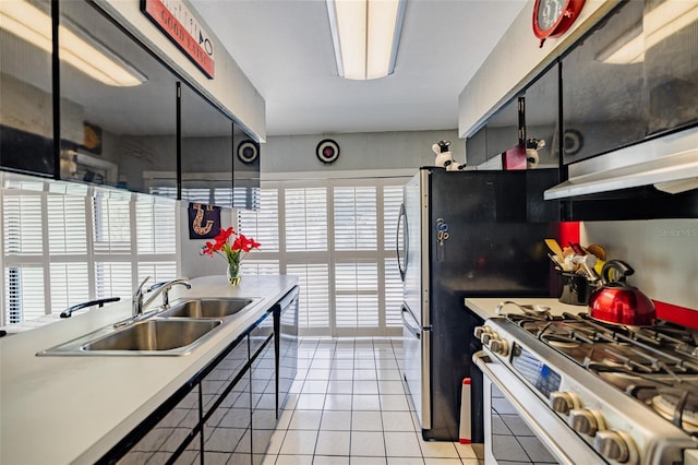 1022 Greenbriar Dr, Brandon, FL 33511 - kitchen with appliances with stainless steel finishes, a sink, extractor fan, light tile patterned floors, and light countertops