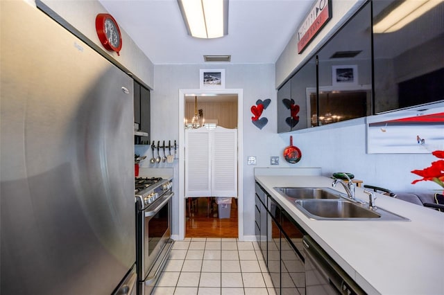 1022 Greenbriar Dr, Brandon, FL 33511 - kitchen with stainless steel appliances, a sink, light tile patterned flooring, and light countertops