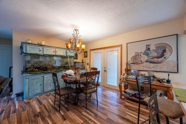 1468 Wigmore St SE, Palm Bay, FL 32909 - dining space featuring dark wood-style flooring, a chandelier, a textured ceiling, and french doors