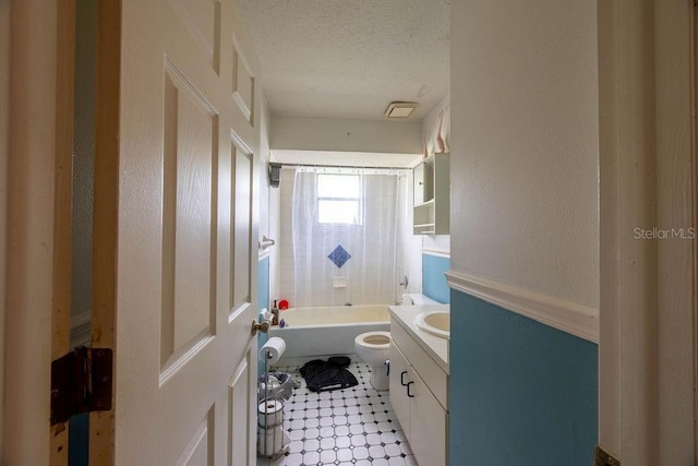 1468 Wigmore St SE, Palm Bay, FL 32909 - bathroom with vanity, toilet, a textured ceiling, tub / shower combination, and tile patterned floors