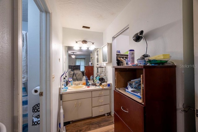 1468 Wigmore St SE, Palm Bay, FL 32909 - full bathroom featuring vanity, wood finished floors, and a textured ceiling
