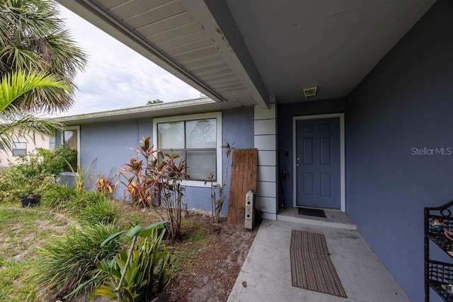 1468 Wigmore St SE, Palm Bay, FL 32909 - doorway to property with stucco siding