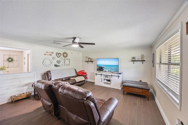 3217 Mott Rd, Dover, FL 33527 - living room featuring hardwood / wood-style floors, a textured ceiling, ceiling fan, ornamental molding, and baseboards
