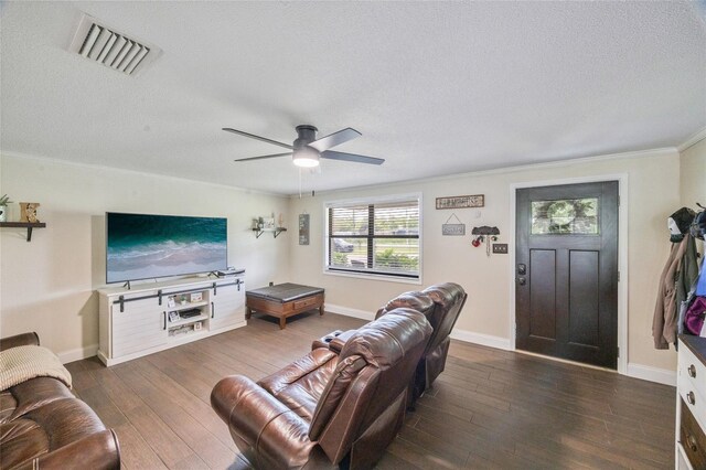 3217 Mott Rd, Dover, FL 33527 - living area featuring dark wood-type flooring, crown molding, a textured ceiling, a ceiling fan, and baseboards