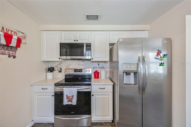 3217 Mott Rd, Dover, FL 33527 - kitchen featuring appliances with stainless steel finishes, light countertops, white cabinets, and backsplash