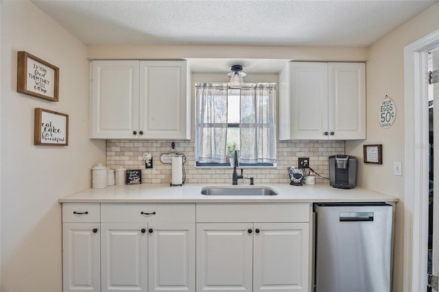 3217 Mott Rd, Dover, FL 33527 - kitchen featuring stainless steel dishwasher, a sink, tasteful backsplash, and white cabinets