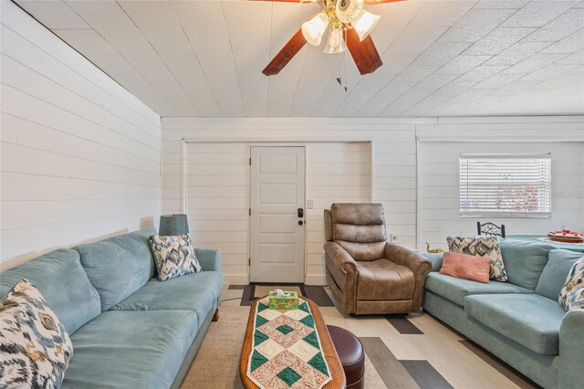 3217 Mott Rd, Dover, FL 33527 - living area featuring wood finished floors, wooden walls, and a ceiling fan