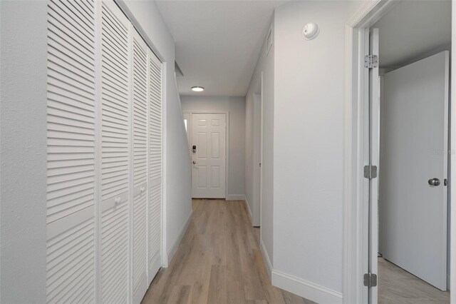 500 New York Ave Unit 23, Dunedin, FL 34698 - corridor with baseboards and light wood finished floors