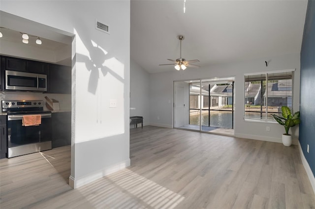 500 New York Ave Unit 23, Dunedin, FL 34698 - unfurnished living room featuring light wood-style flooring, ceiling fan, baseboards, and lofted ceiling