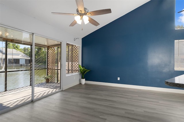 500 New York Ave Unit 23, Dunedin, FL 34698 - spare room with a ceiling fan, healthy amount of natural light, wood finished floors, and vaulted ceiling