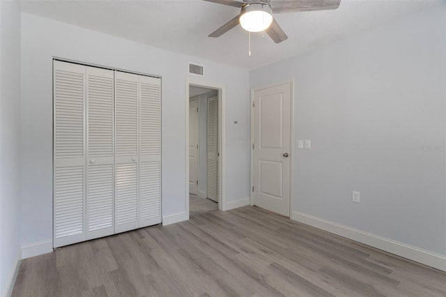 500 New York Ave Unit 23, Dunedin, FL 34698 - unfurnished bedroom featuring wood finished floors, a closet, and baseboards