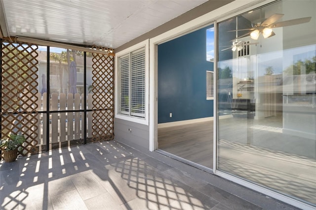 500 New York Ave Unit 23, Dunedin, FL 34698 - unfurnished sunroom featuring ceiling fan and baseboards