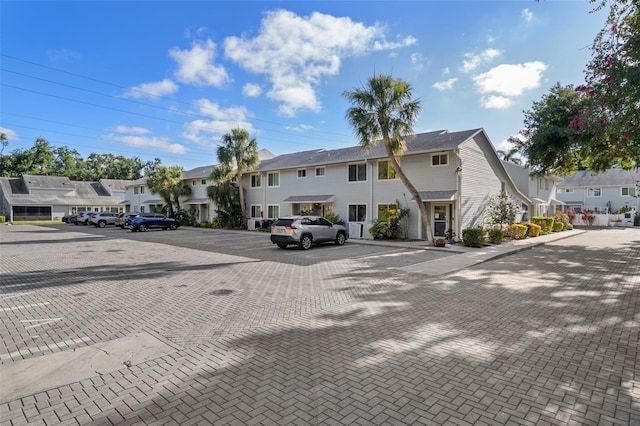 500 New York Ave Unit 23, Dunedin, FL 34698 - view of front of house with a residential view and uncovered parking