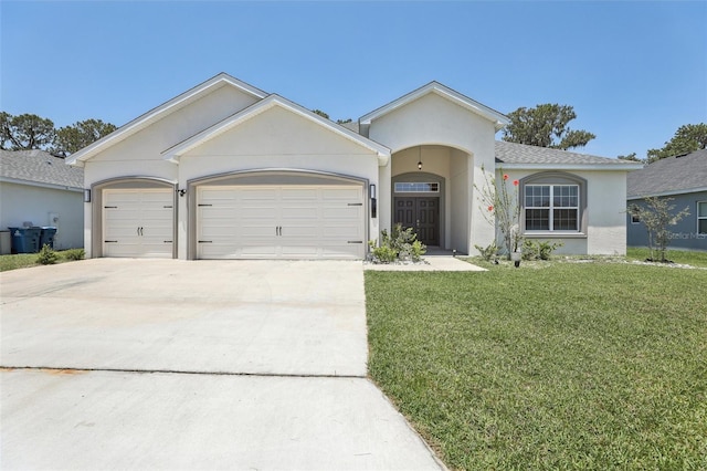 229 St Thomas Dr, Mulberry, FL 33860 - view of front of property with driveway, a garage, a front lawn, and stucco siding