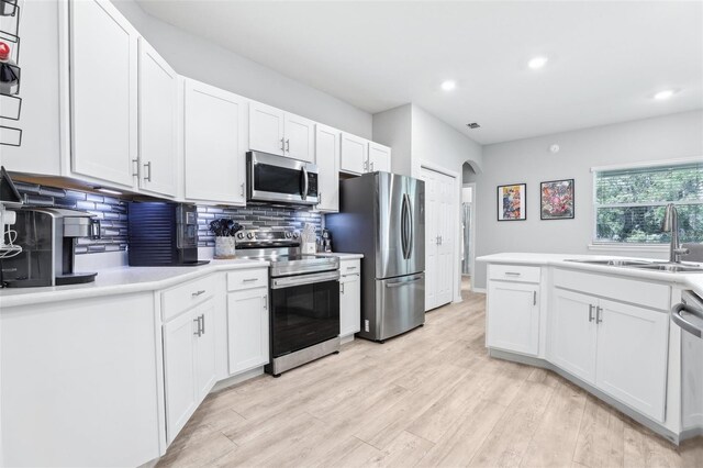 229 St Thomas Dr, Mulberry, FL 33860 - kitchen featuring appliances with stainless steel finishes, a sink, tasteful backsplash, recessed lighting, and white cabinets