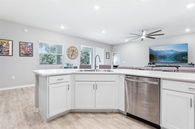 229 St Thomas Dr, Mulberry, FL 33860 - kitchen featuring stainless steel dishwasher, a sink, light countertops, white cabinets, and recessed lighting