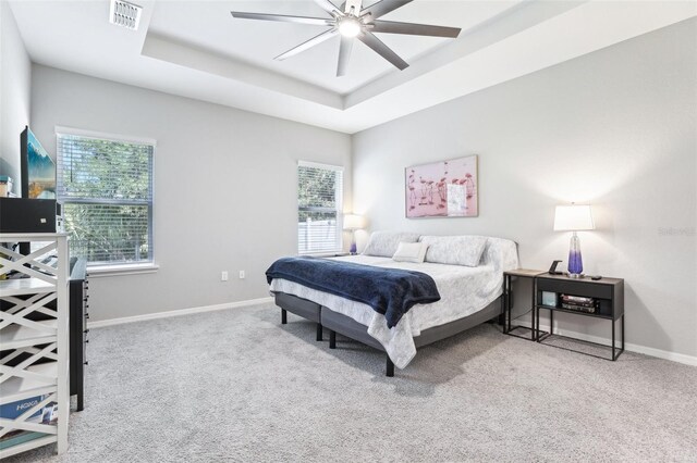 229 St Thomas Dr, Mulberry, FL 33860 - carpeted bedroom featuring a raised ceiling, multiple windows, baseboards, and ceiling fan