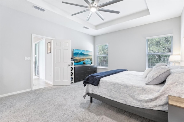 229 St Thomas Dr, Mulberry, FL 33860 - carpeted bedroom with a raised ceiling, multiple windows, ceiling fan, and baseboards