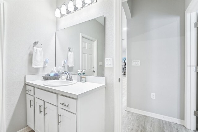 229 St Thomas Dr, Mulberry, FL 33860 - bathroom with vanity, wood finished floors, and baseboards