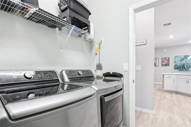 229 St Thomas Dr, Mulberry, FL 33860 - washroom with light wood-style flooring, washing machine and clothes dryer, and baseboards