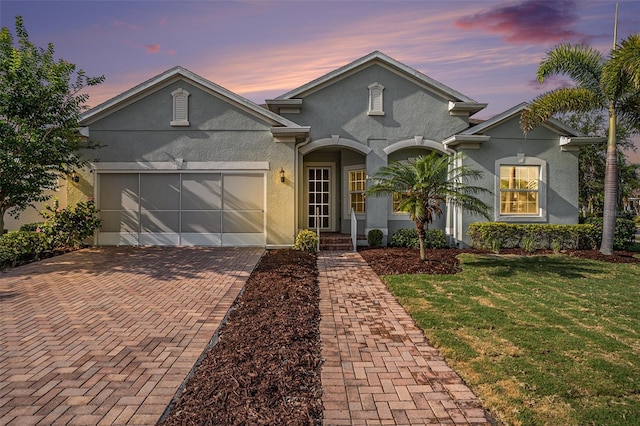 212 Shell Creek Ct, Apollo Beach, FL 33572 - view of front of home with stucco siding, decorative driveway, a front yard, and an attached garage