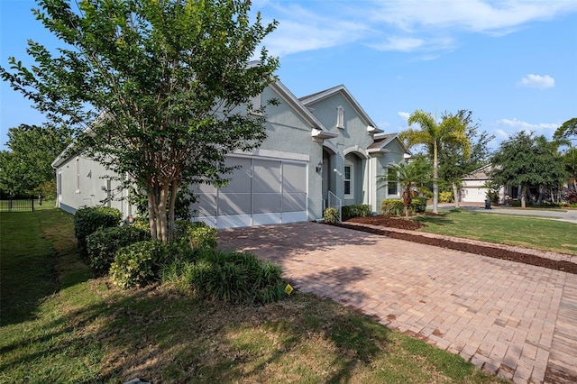 212 Shell Creek Ct, Apollo Beach, FL 33572 - view of front facade with decorative driveway, a front lawn, a garage, and stucco siding