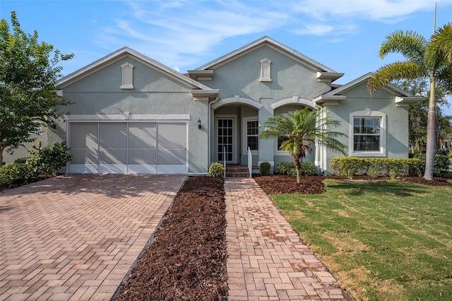 212 Shell Creek Ct, Apollo Beach, FL 33572 - view of front of property with stucco siding, decorative driveway, a front lawn, and a garage